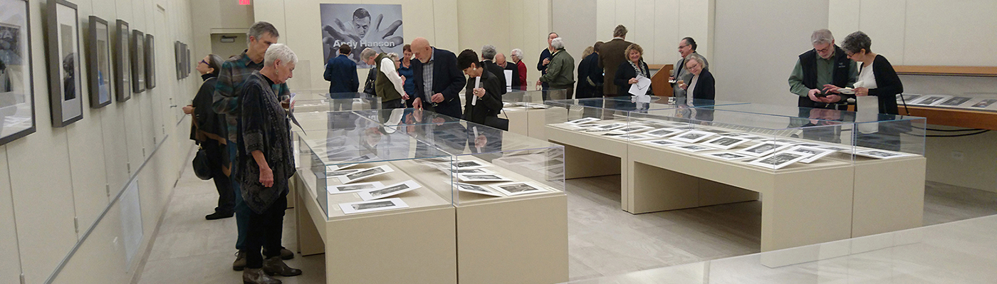 people looking at glass exhibit cases