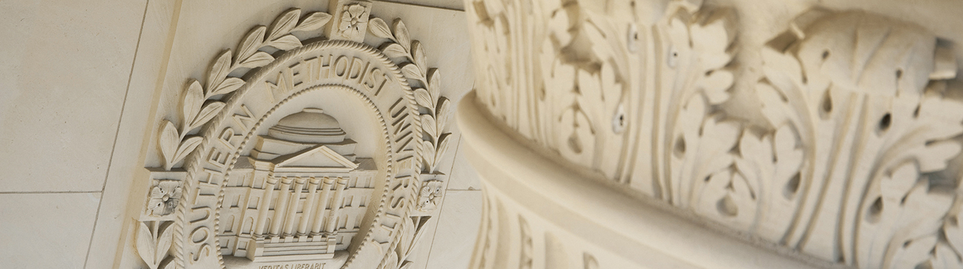 scroll on top of column with smu seal on wall