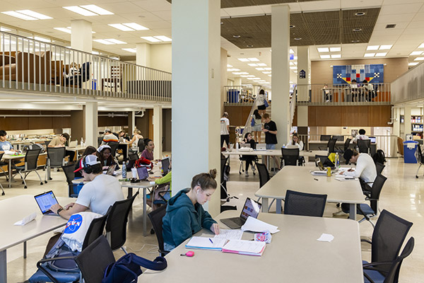 Students at study table with Mezzanine area in the background