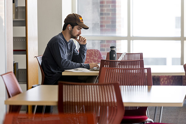 Student at table in Hamon Arts Library third-floor study area