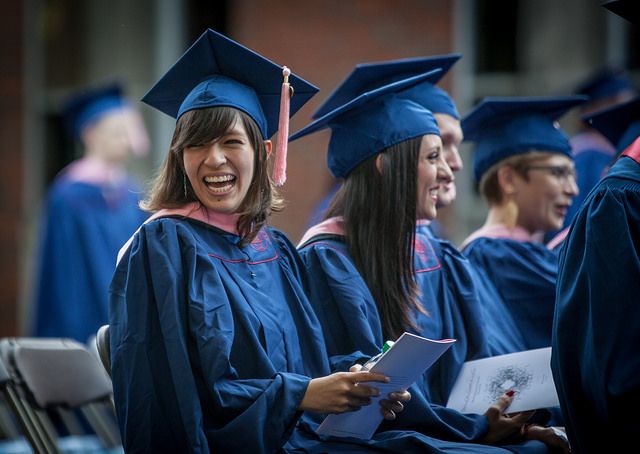 Female students graduating and laughing