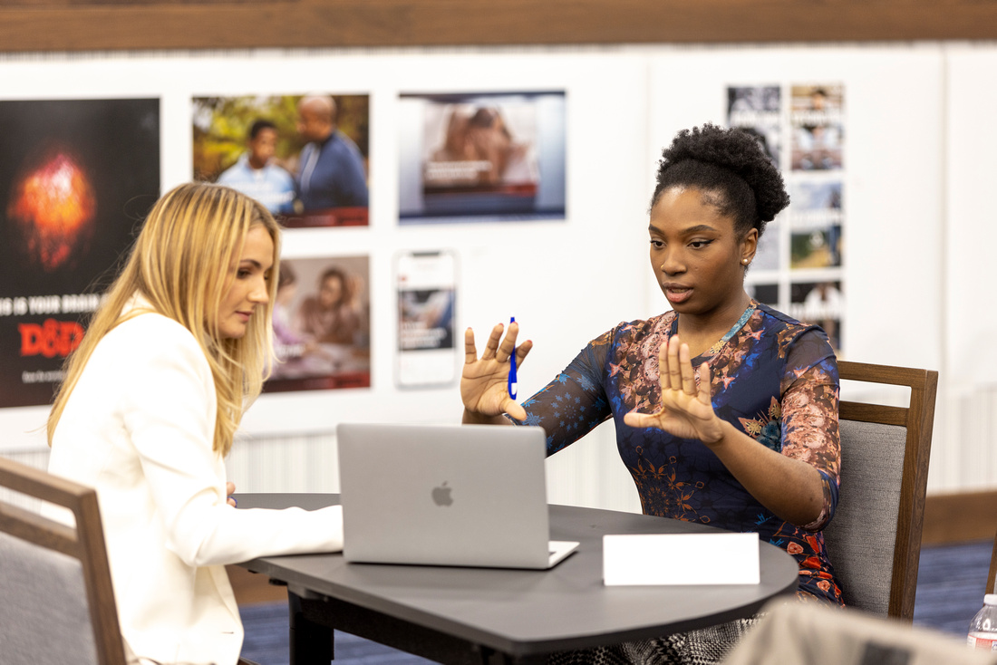 two female students work together at a desk