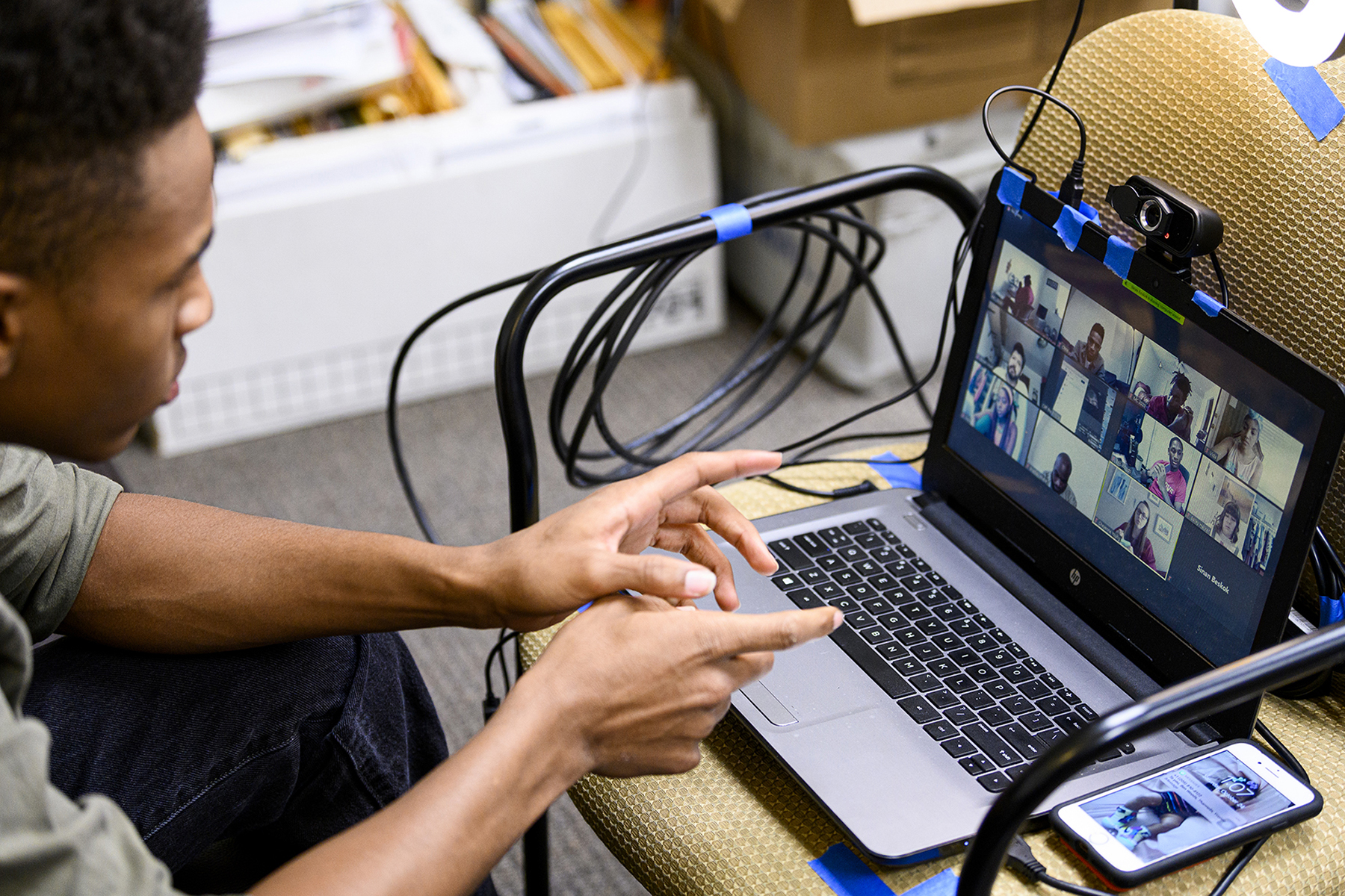 black student editing film on a laptop