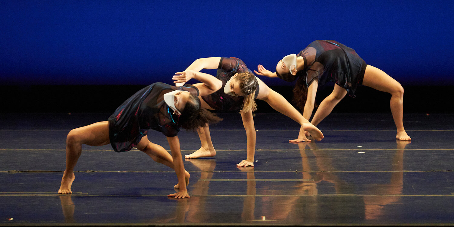 three female dancers against in a blue background