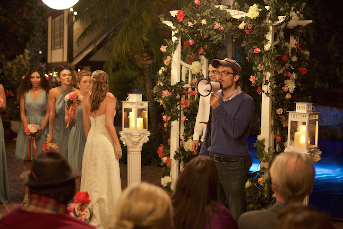 Alum Thane Economou (B.A. '10) directs actors on the set of his movie, The Wedding Party.