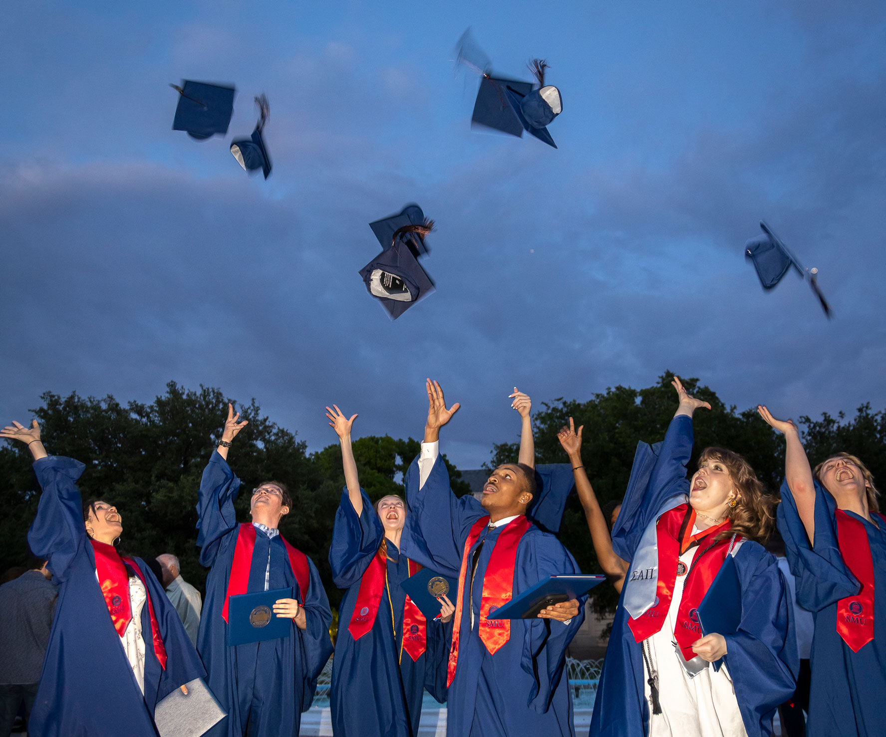 Graduates throw their caps into the evening air following the 2023 Degree Recognition Ceremony.