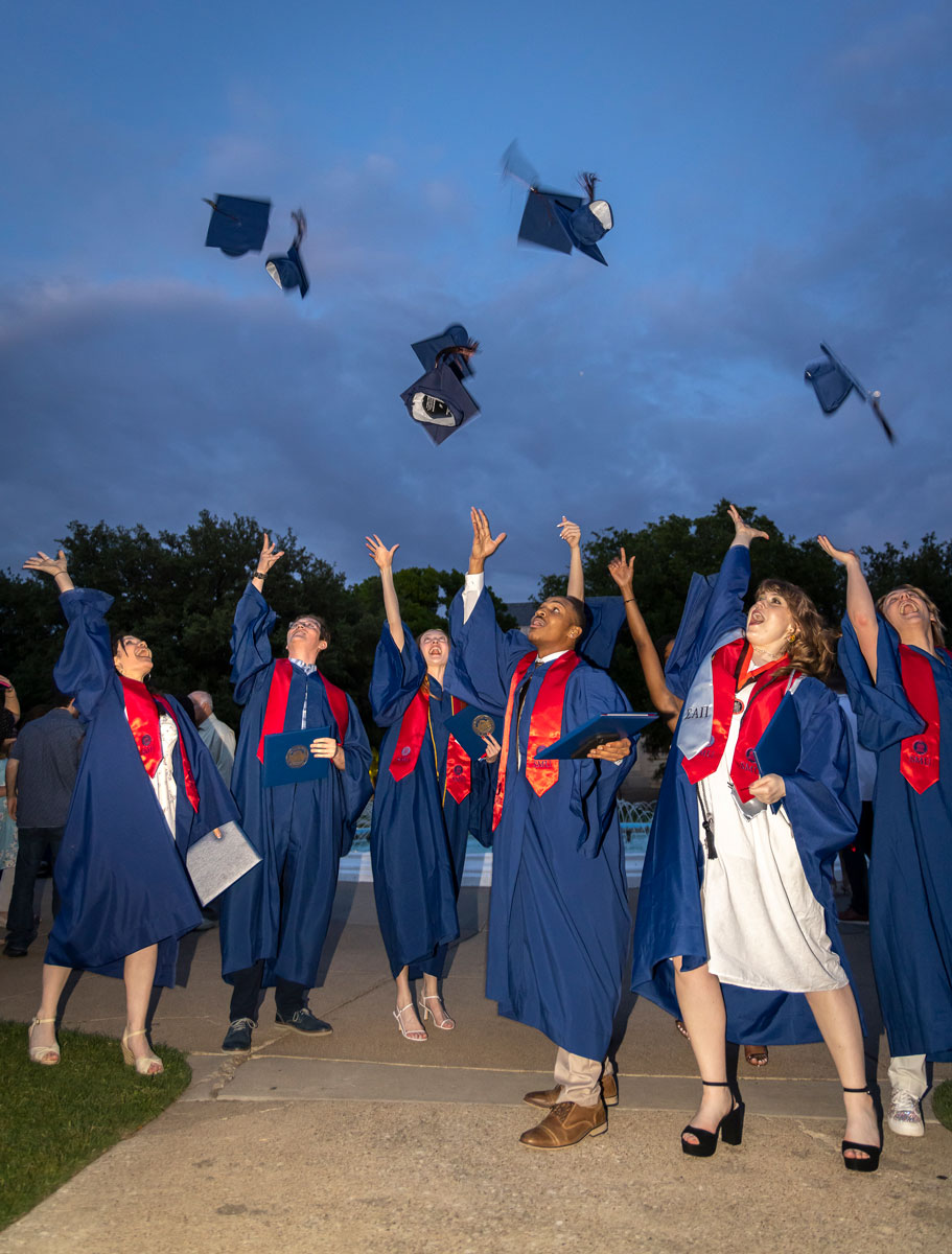 Graduates throw their caps into the evening air following the 2023 Degree Recognition Ceremony.
