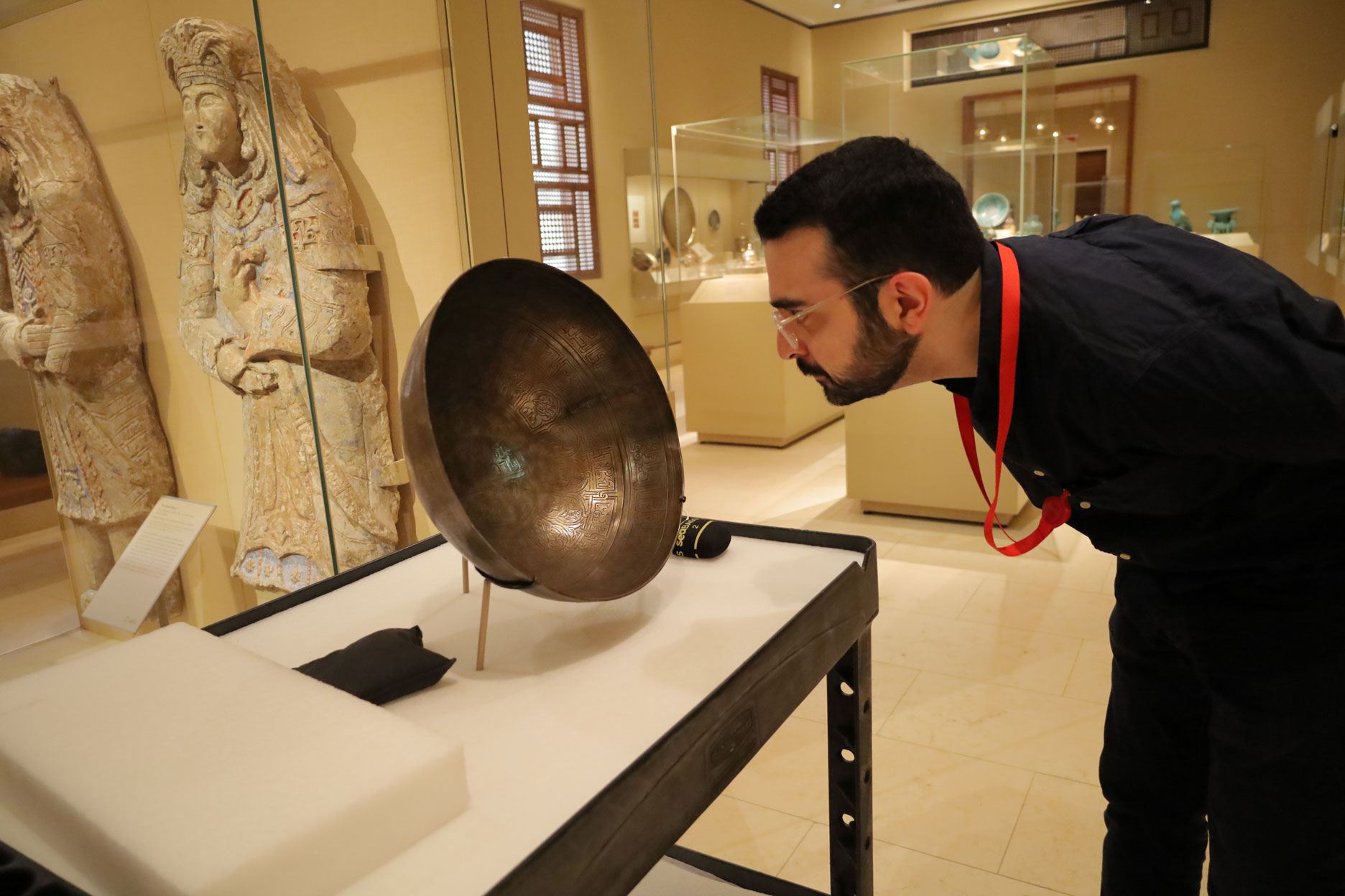 Sixth year Ph.D. student Arvin Maghsoudlou examines a piece of work for his art history program.