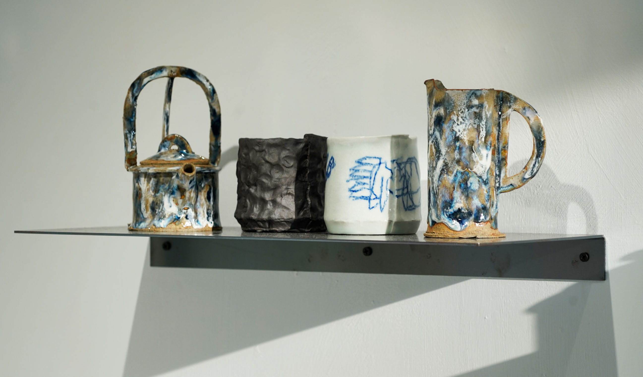 A collection of ceramic teaware featured in Brian Molanphy's solo exhibition.