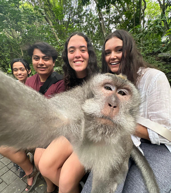 Students interact with native species at the Sacred Monkey Forest Sanctuary in Bali.