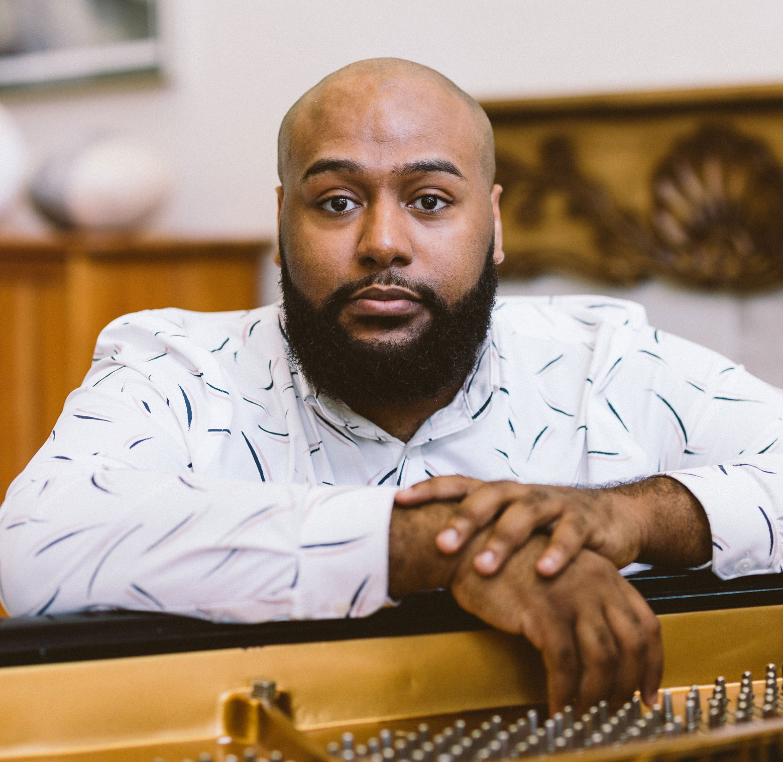 Award winner Lewis Warren Jr. poses at the piano