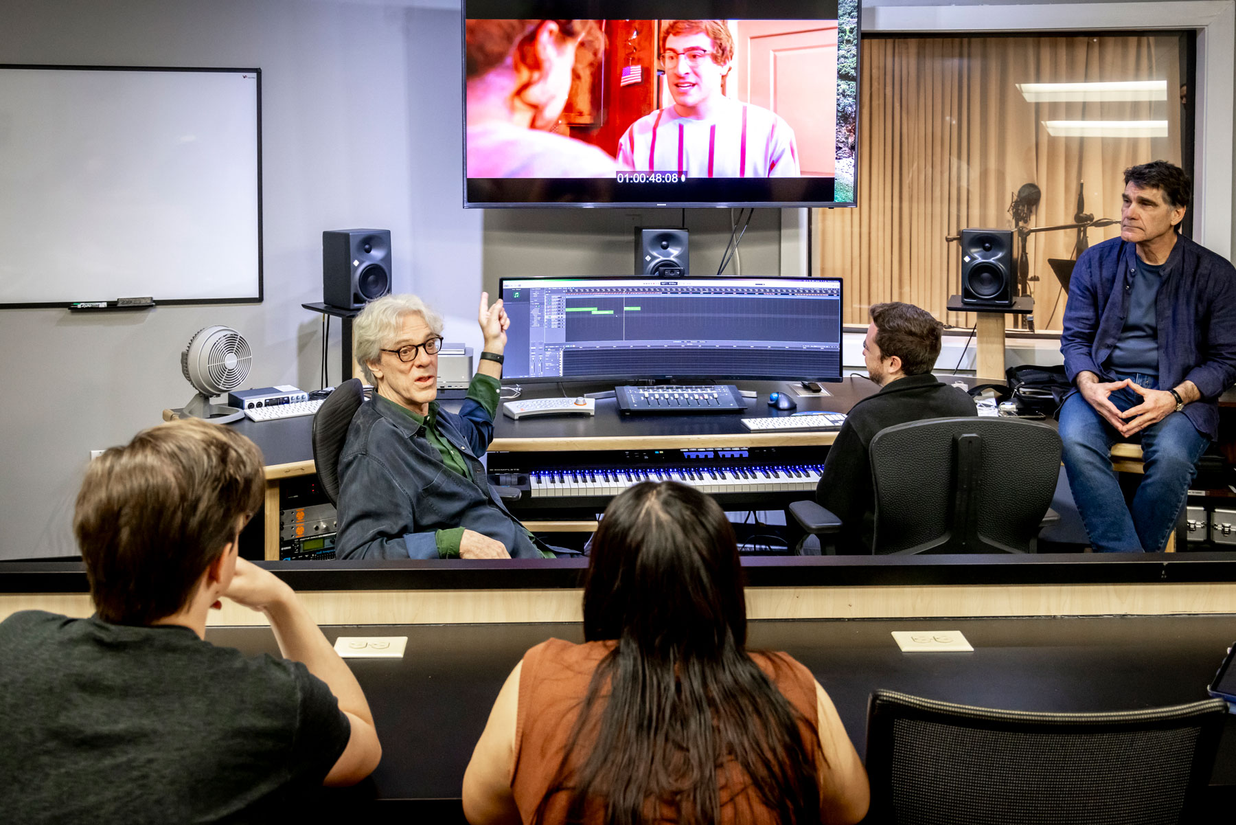 Students gather in Meadows new electronic recording studio for a film and game scoring class.