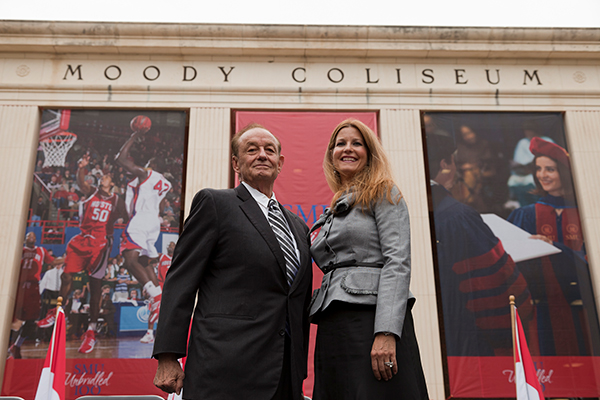 Robert L. ‘Bobby’ Moody, Sr and Frances Moody-Dahlberg '92 posing for a photo in front of the Moody Coliseum