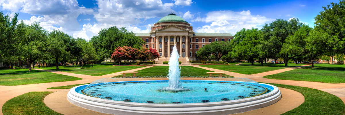 Panoramic image of the SMU quad and fountain with Dallas Hall in the background.