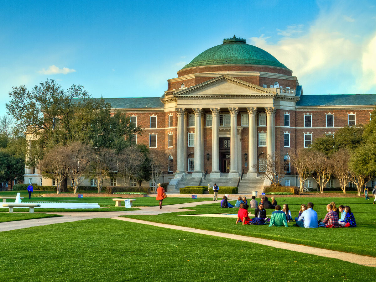 Clusters of students study on the SMU quad. 