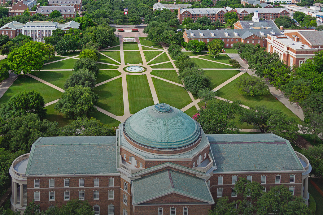 Aerial photograph of SMU's Dallas campus from behind Dallas Hall looking toward the flagpole with a gradient overlay
