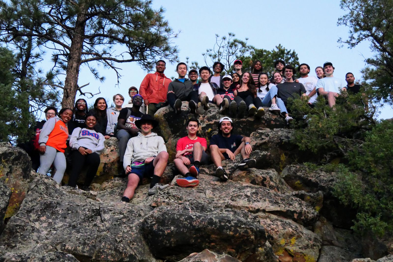 A group of mostly President's Scholars at the top of the Orange Trail at the SMU-in-Taos campus right at sunrise