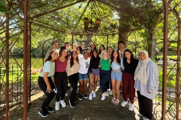 group photo of scholars standing in a gazebo 