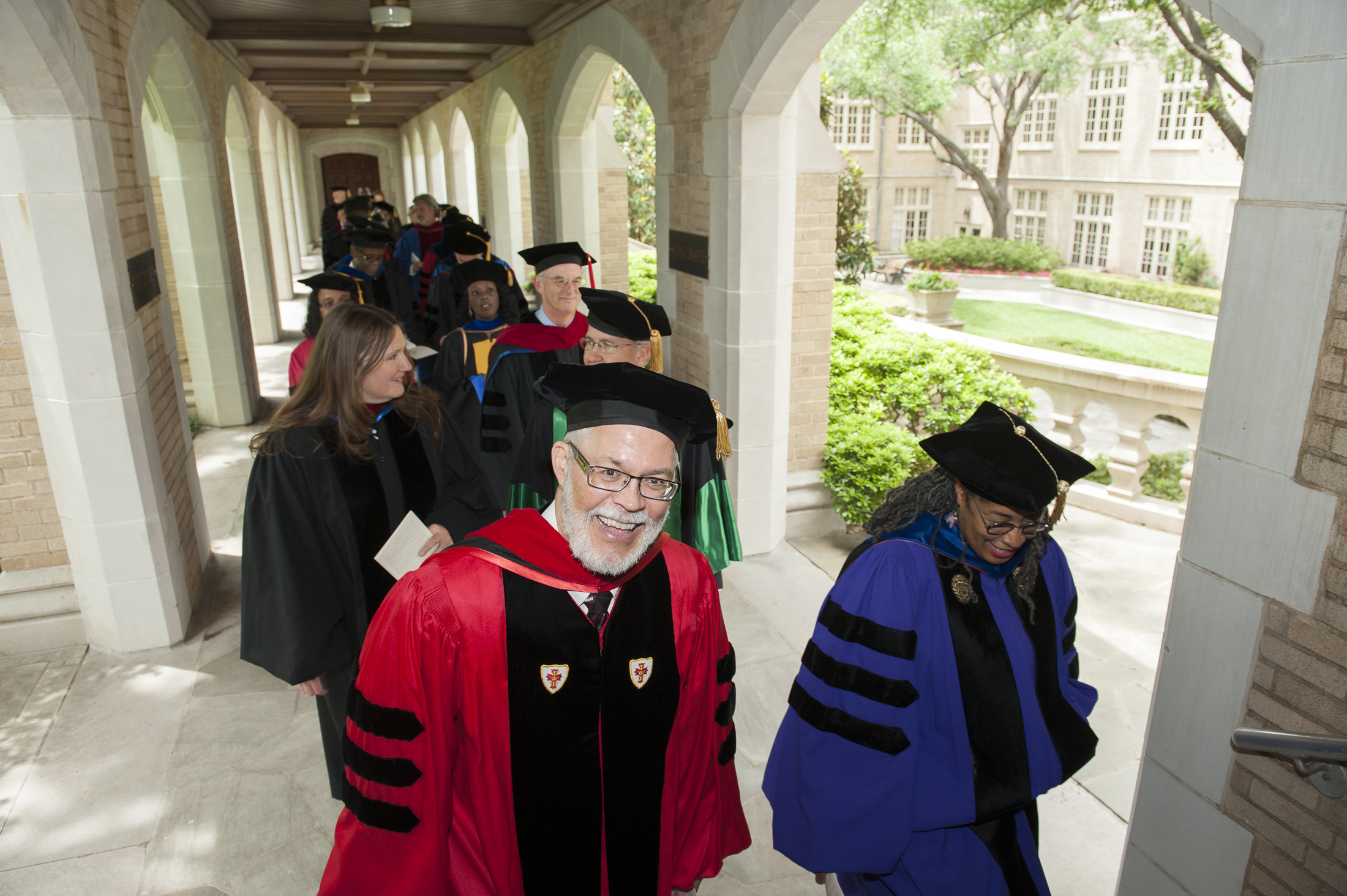 faculty walking in ceremony robe