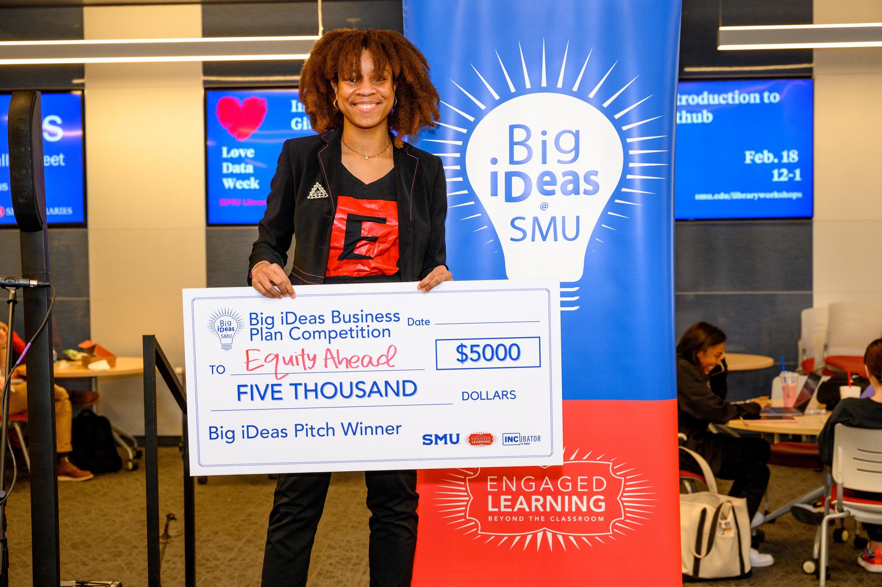 Tyne Dickson, founder of Equity Ahead, with her big check at the Big iDeas competition