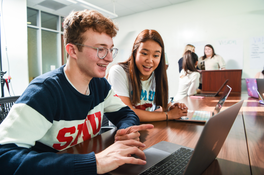 students looking at computer