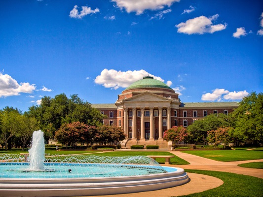 Dallas Hall in background, fountain in foreground, on a beautiful spring day