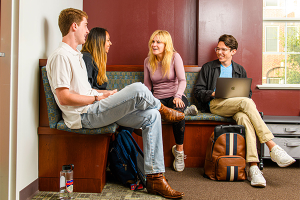 Students sitting indoors talking