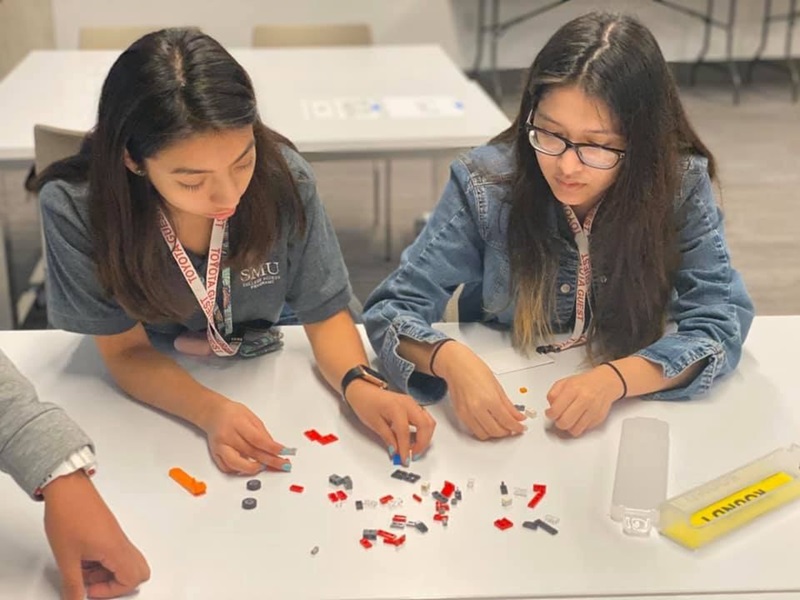 Upward Bound and Upward Bound Math Science Scholars participating in a lego activity at Toyota's Manufacturing Day event.
