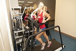 Research participant jogging on a treadmill in a room for data collection