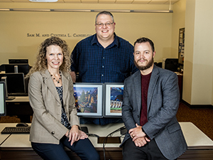 Dr. Geller, Dr. Clark, and Dr. Larson sitting next to computer showing Minecraft.
