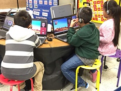 Focused students engaged in laptop-based learning using natural language processing (NLP) software during research study.
