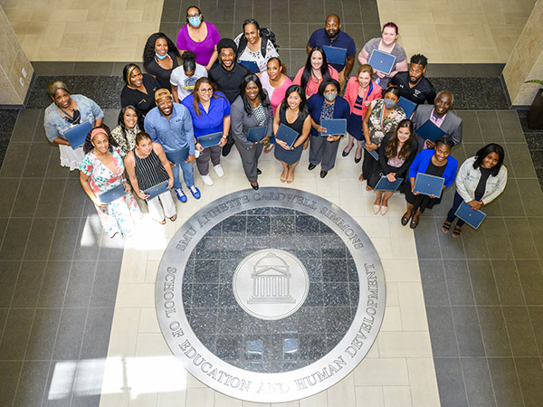 West Dallas Stem School Teachers and Principle in the Annette Caldwell Simmons Hall Atrium.