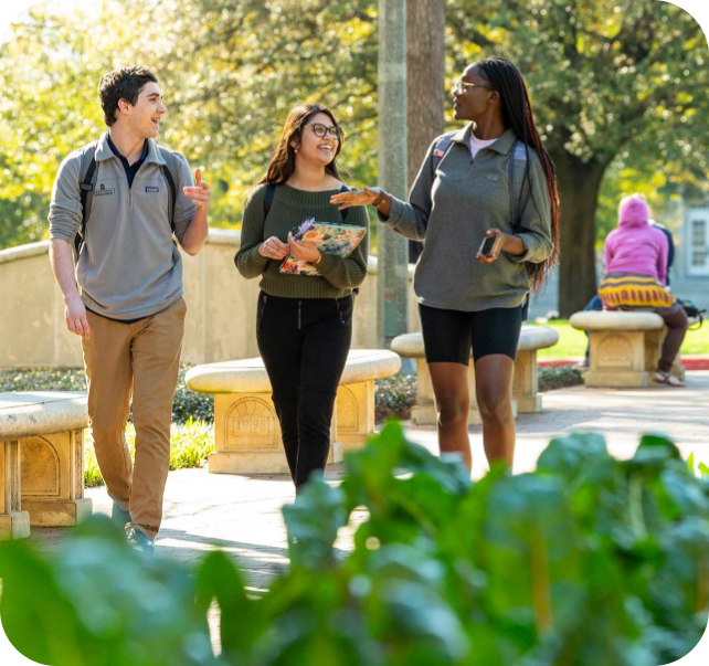 3 students walking on campus