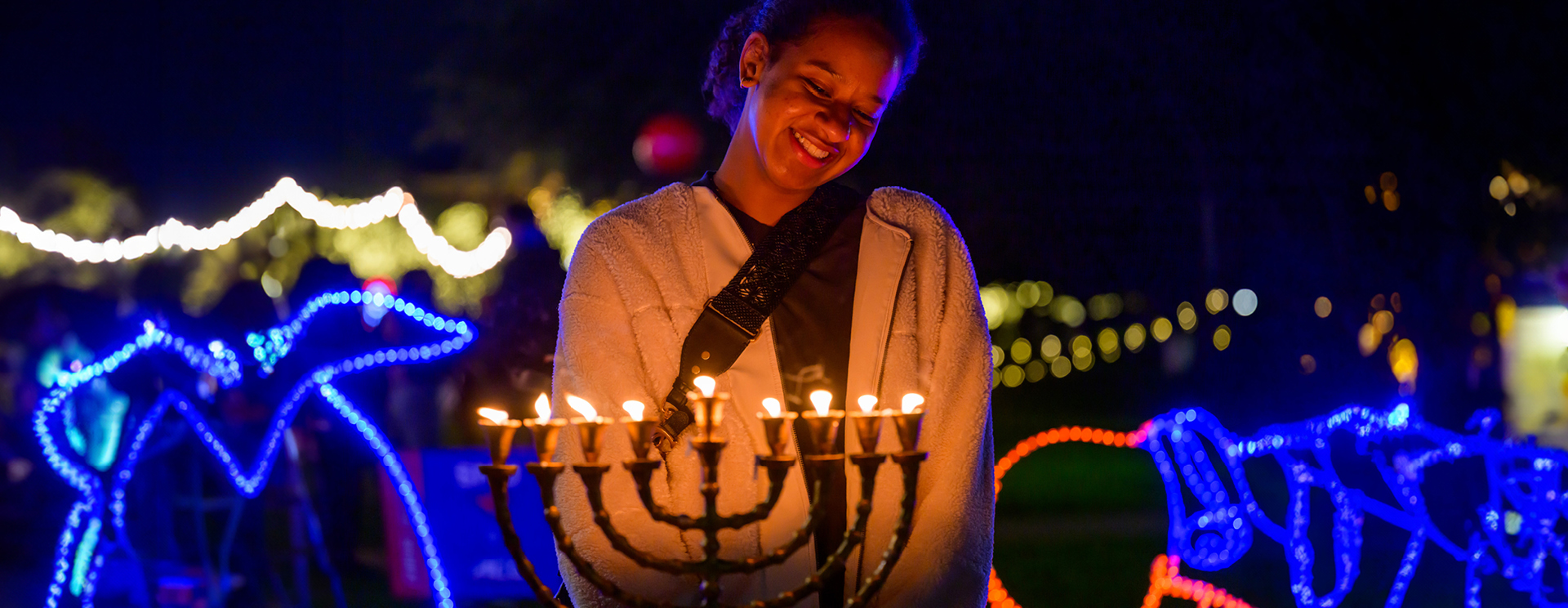 Student lighting the menorah