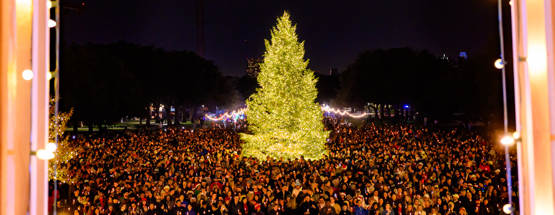 The Christmas tree lit up with a crowd surrounding it at the Celebration of lights