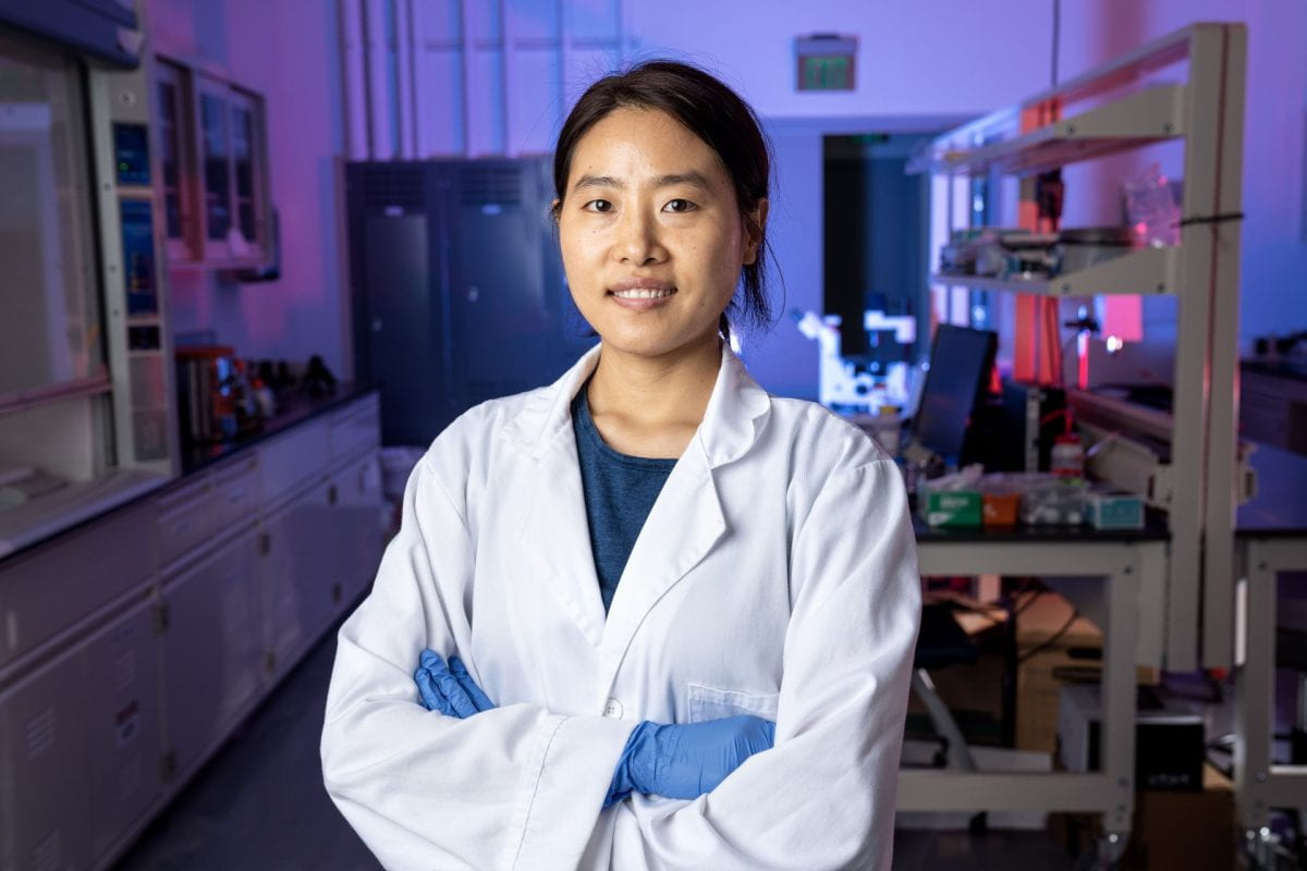 Khengdauliu Chawang ’24, a Ph.D. student in electrical and computer engineering at the Lyle School of Engineering, posing for a picture while wearing a white researcher's labcoat