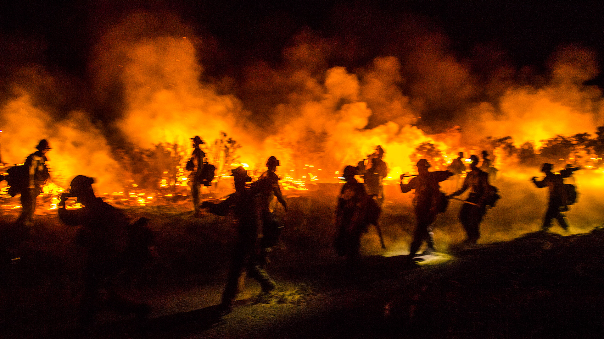 Photo of Firefighters firefighting.