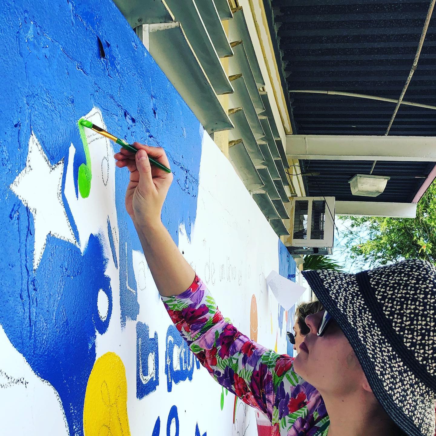 Lacey painting a mural for displaced children in Puerto Rico