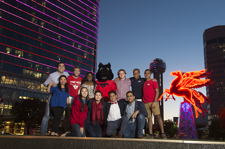 People posing for a group shot in Downtown Dallas.