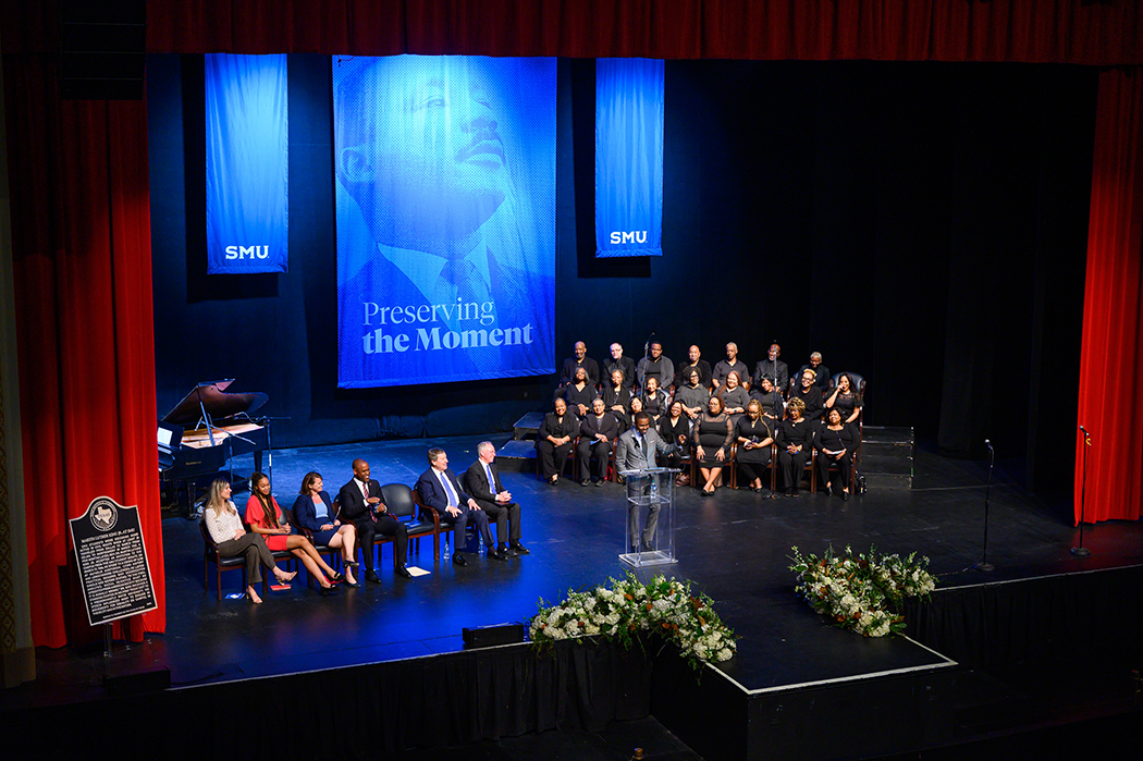 People gathered on stage at Mcfarlin Auditorium to commemorate the plaque dedication for Dr. Martin Luther King Jr.