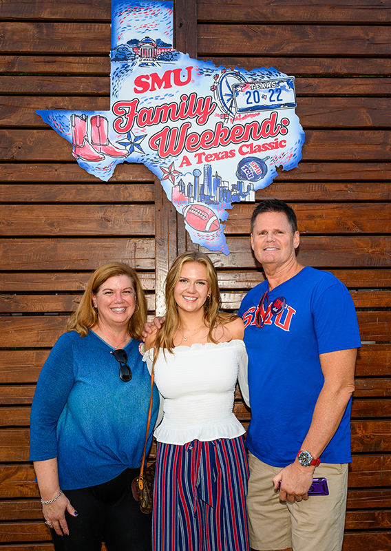 Photo of family in front of SMU sign