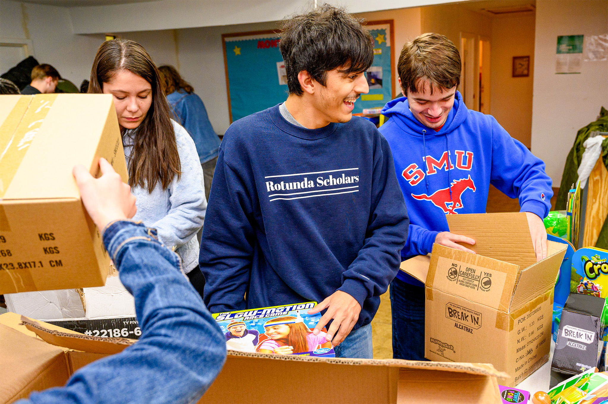 students packing boxes with toys