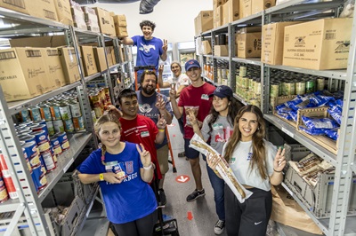 SMU students work at a food pantry during an Engage Dallas event.