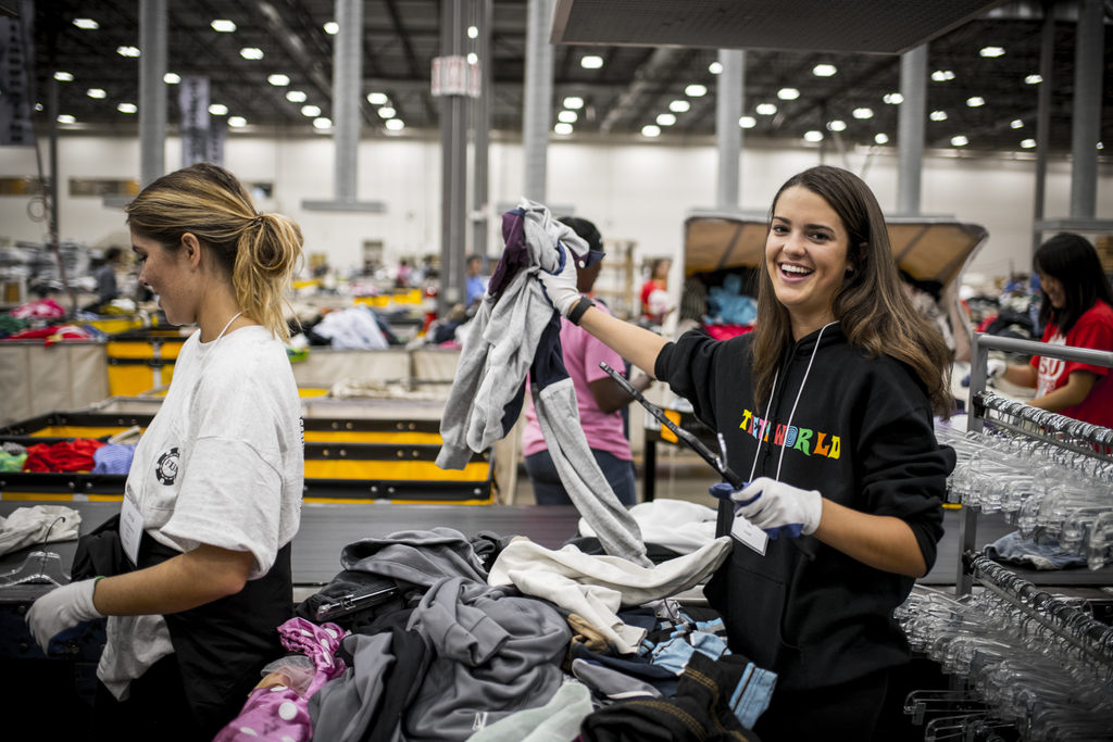 Students sorting clothes in warehouse