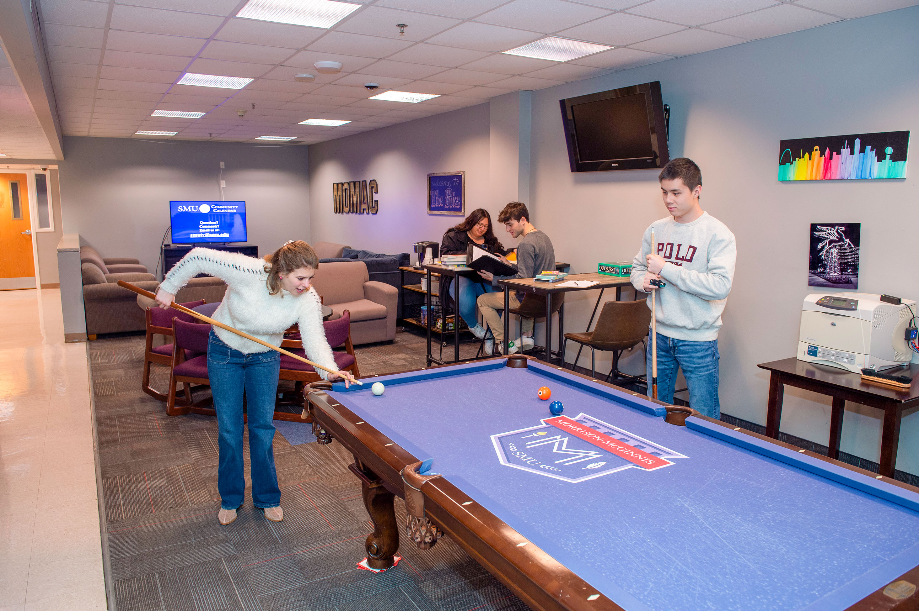 two students playing pool and two students sitting at a table in Morrison-McGinnis Commons