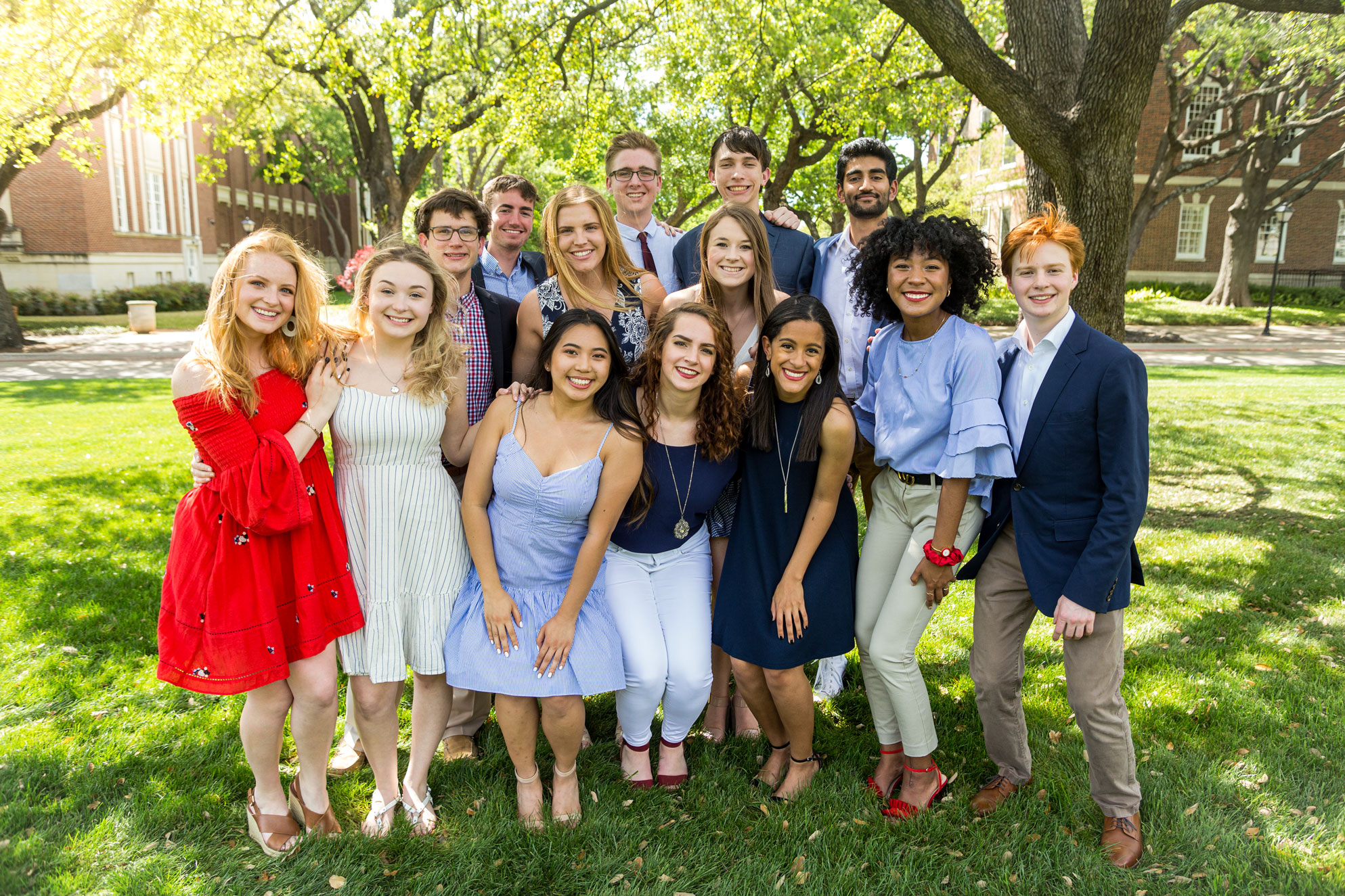 14 orientation leaders posing on Dallas Hall lawn