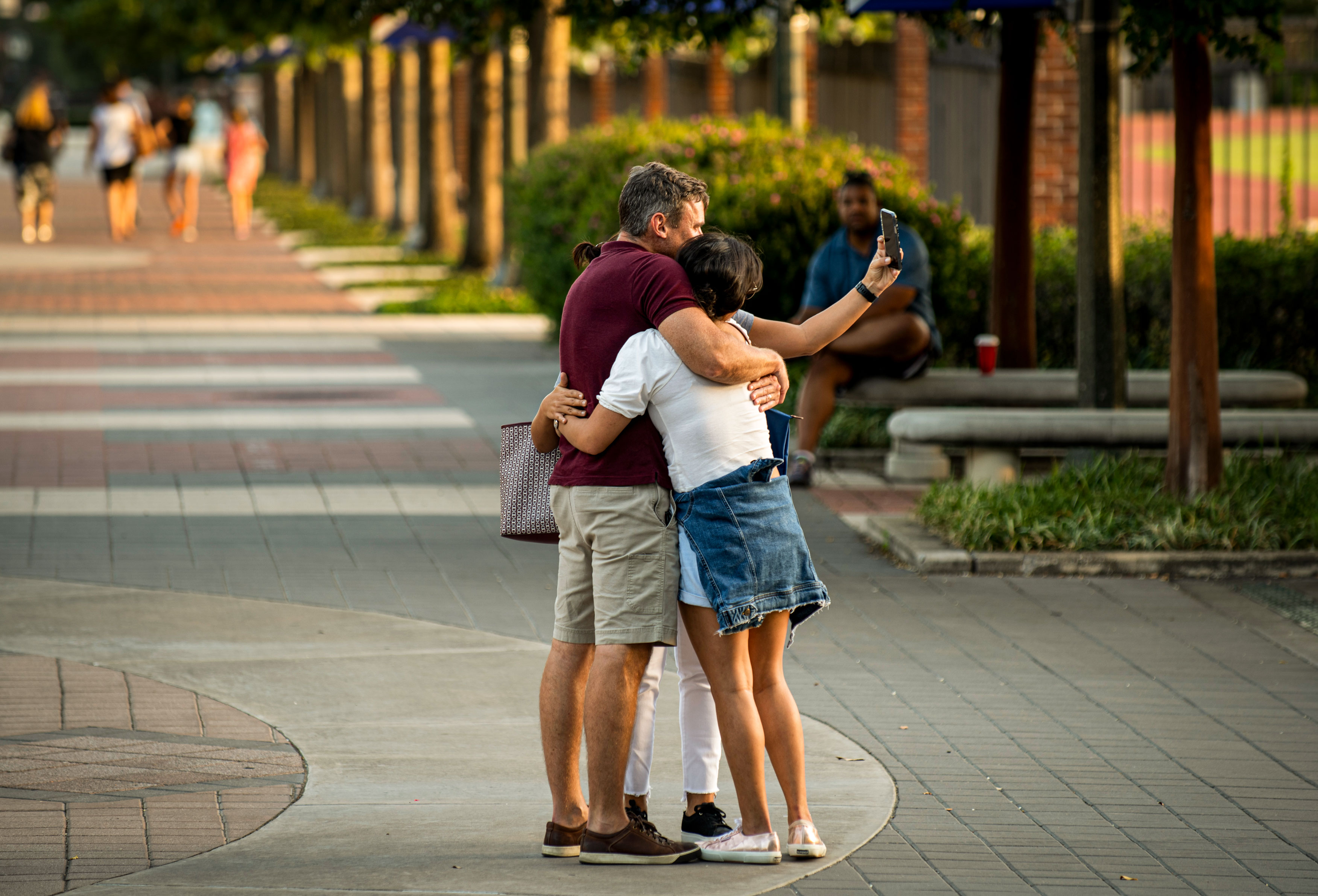 Family hugging and taking selfie on Mustang Mall