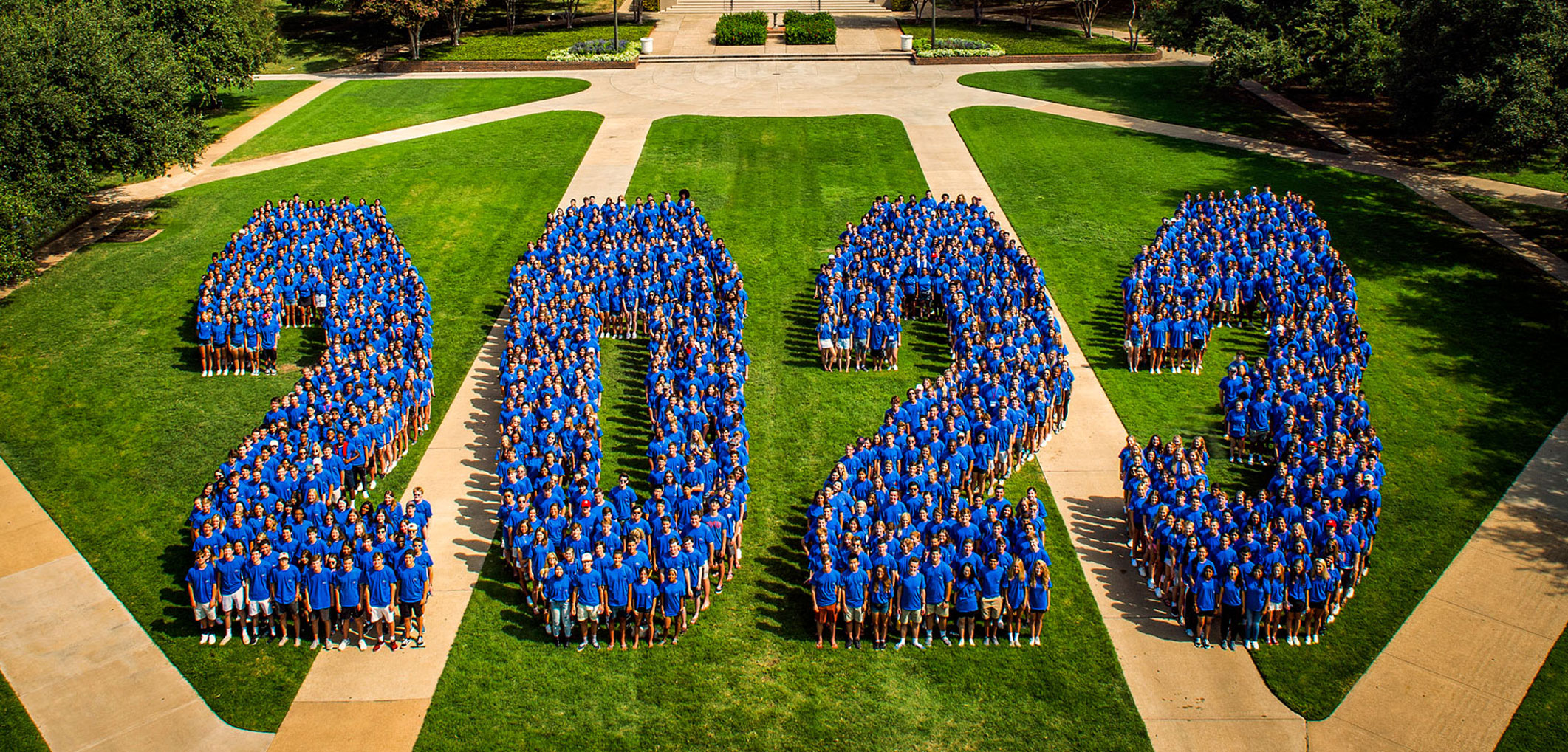 Students standing together to form the shape of "2023" on Dallas Hall Lawn