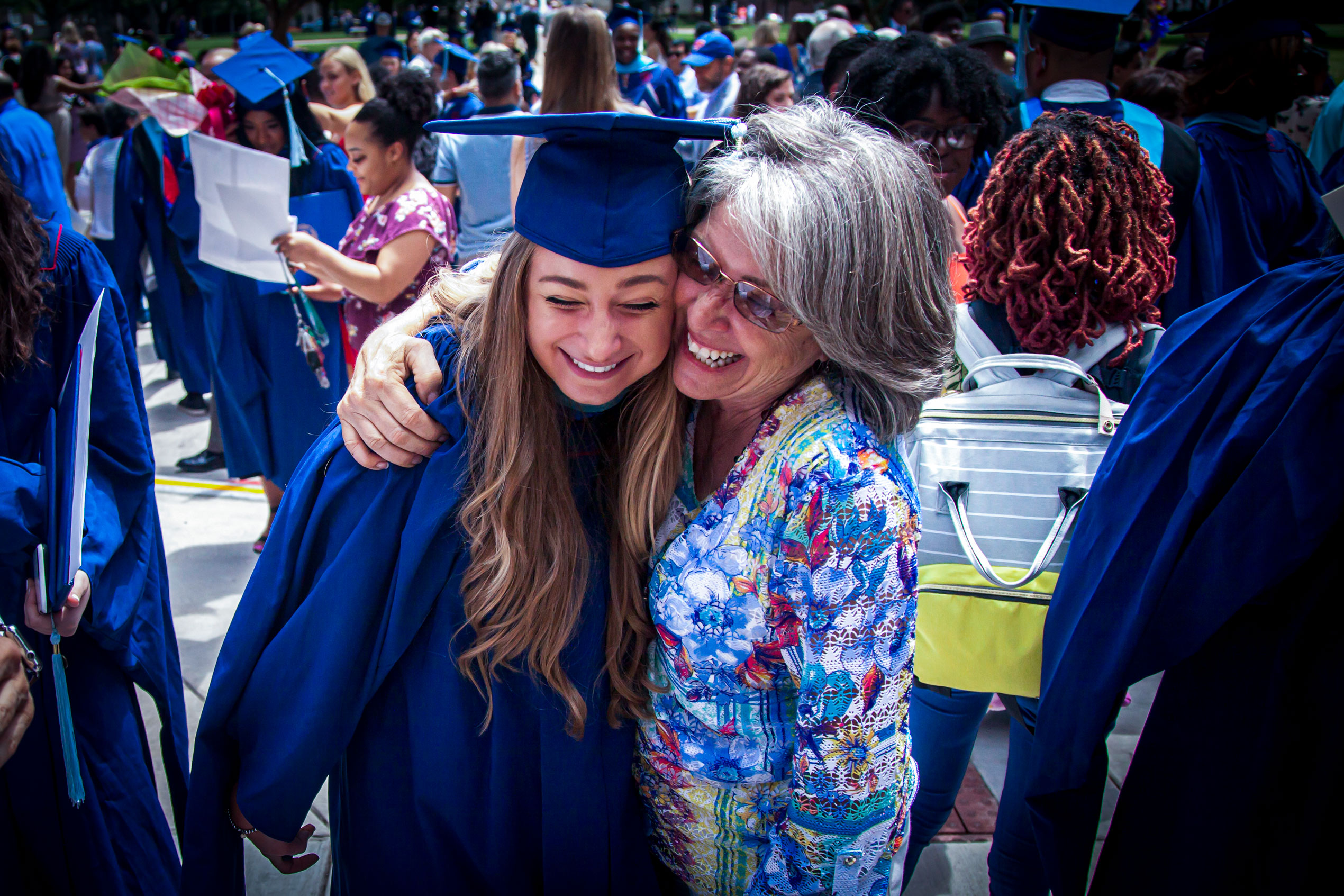 Mom hugging daughter on graduation day