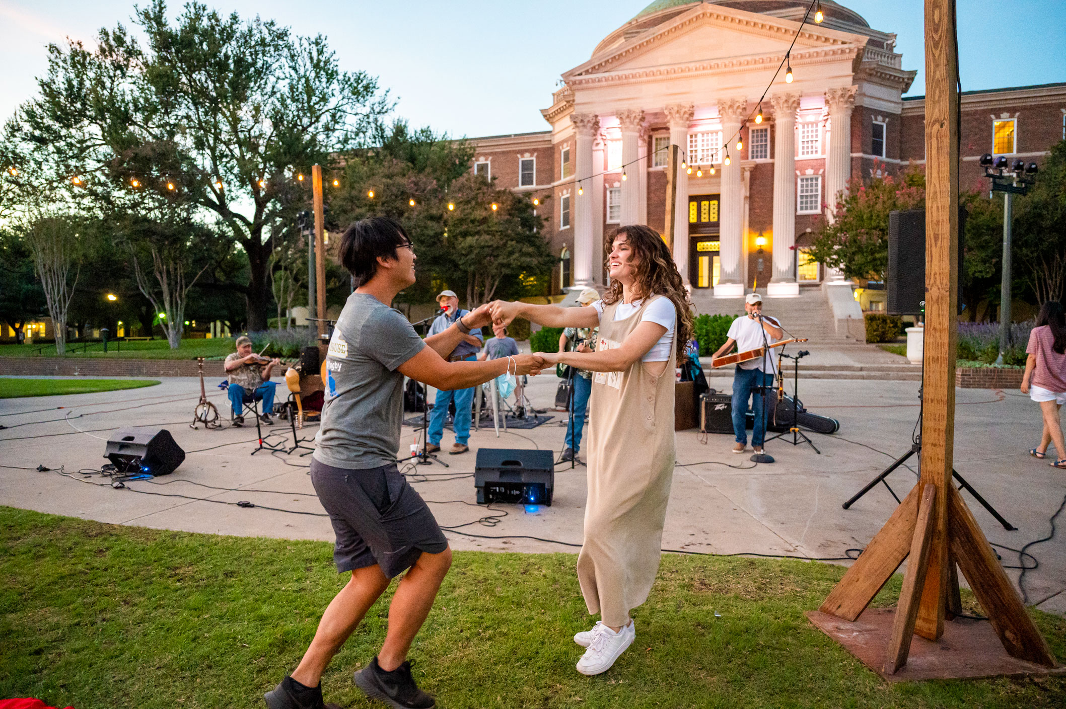 Students dancing at event in front of Dallas Hall